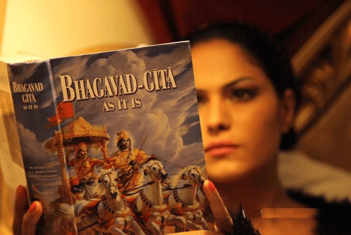 Mentor holding Bhagavad Gita book